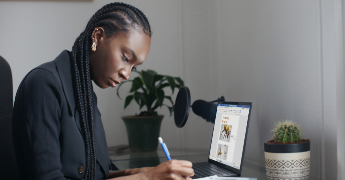 woman writing at desk